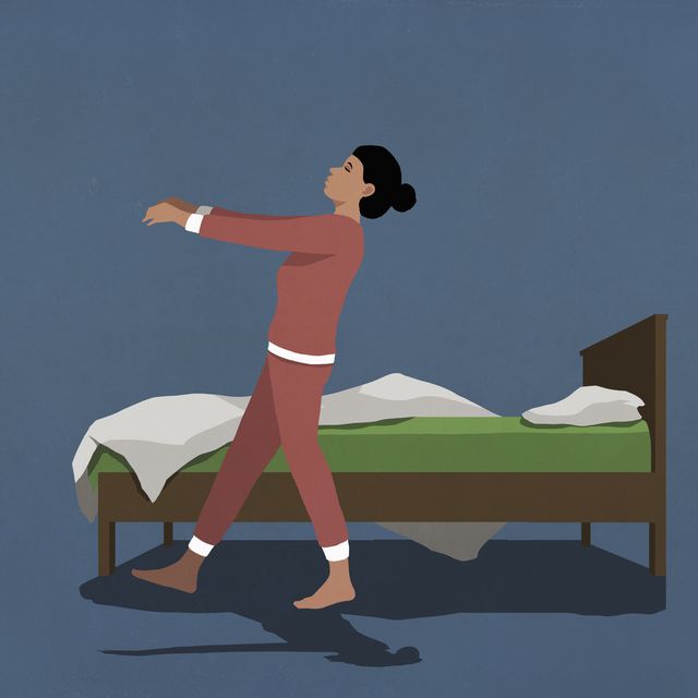 woman in pajamas sleepwalking along bed in nighttime bedroom