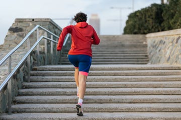 woman in sportswear training on stairs in the city at daytime