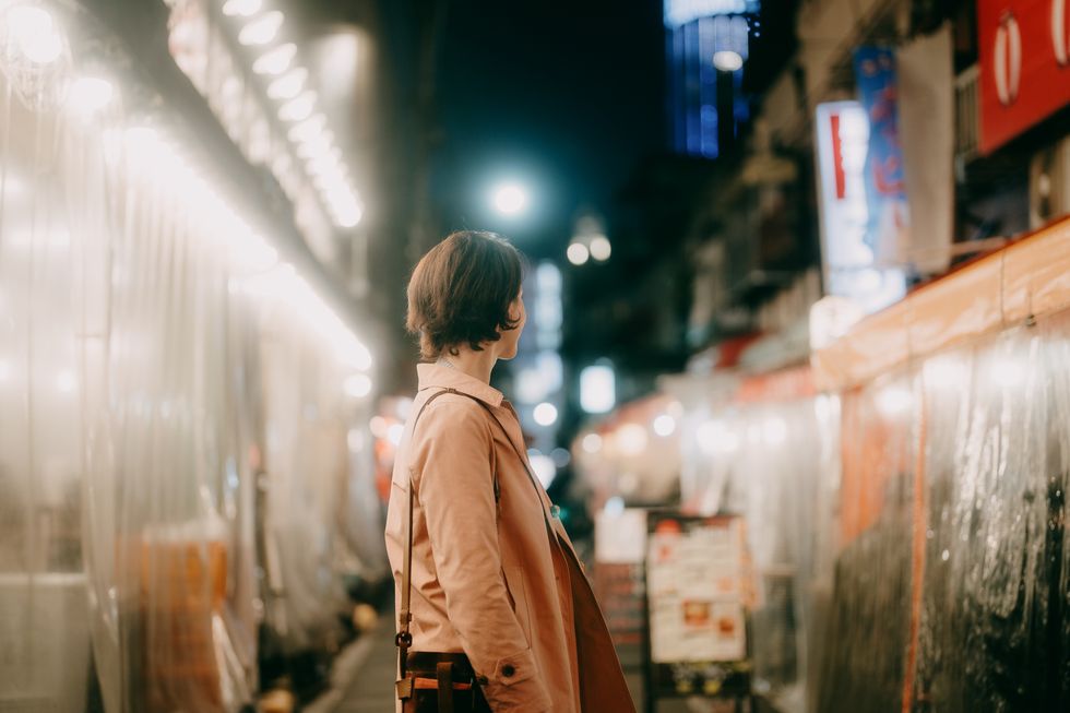 woman in tokyo backstreet at night