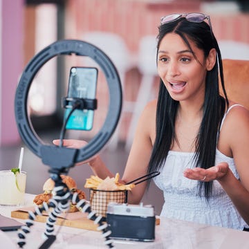 Woman influencer, food review blog and content creator filming online video in cafe restaurant. Creative live streaming, shooting 5g web vlog and virtual mobile phone app broadcast for social media woman influencer, food review blog and content creator filming online video in cafe restaurant creative live streaming, shooting 5g web vlog and virtual mobile phone app broadcast for social media