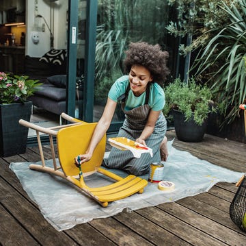 woman is coloring a chair at home