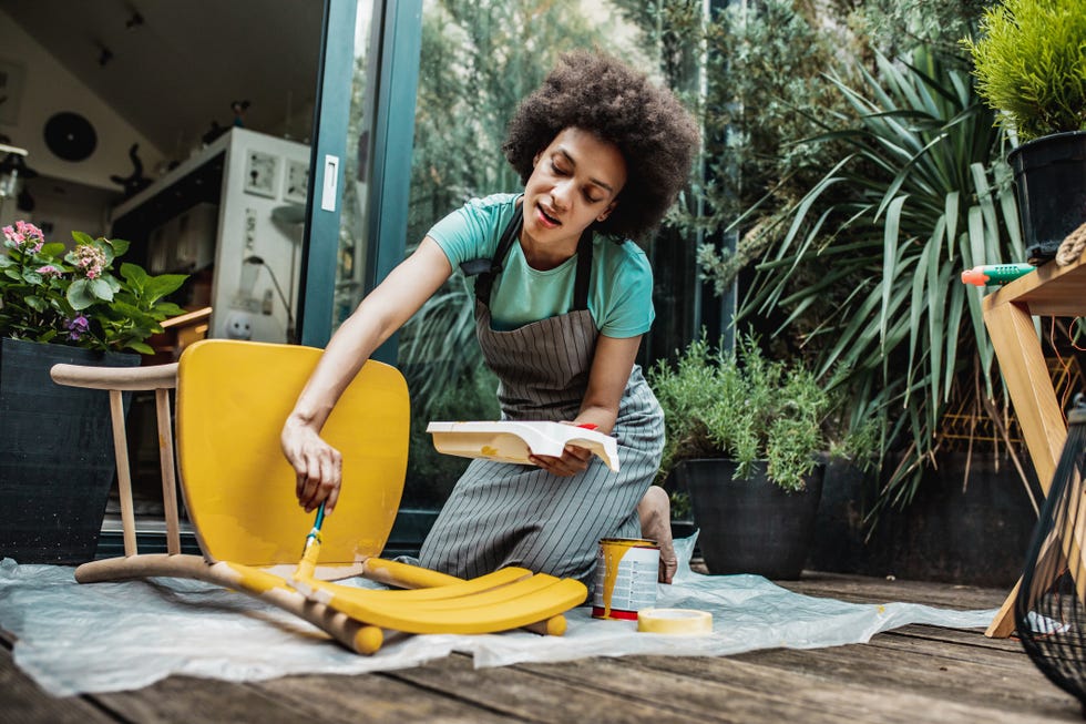 woman is coloring a chair at home