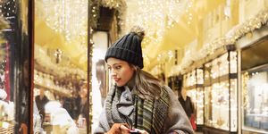 woman is window shopping in decorated street