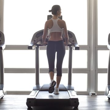 woman jogging on treadmill at gym