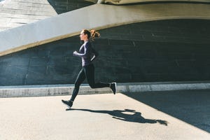 woman jogging or running, side view with shadow