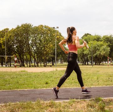 woman jogging outdoors, hydrating