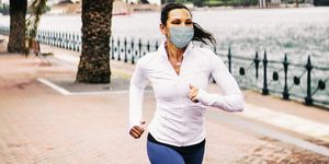 woman jogging wearing healthcare mask for protection how does runnign with mask affect performance