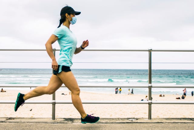 woman jogging wearing healthcare mask