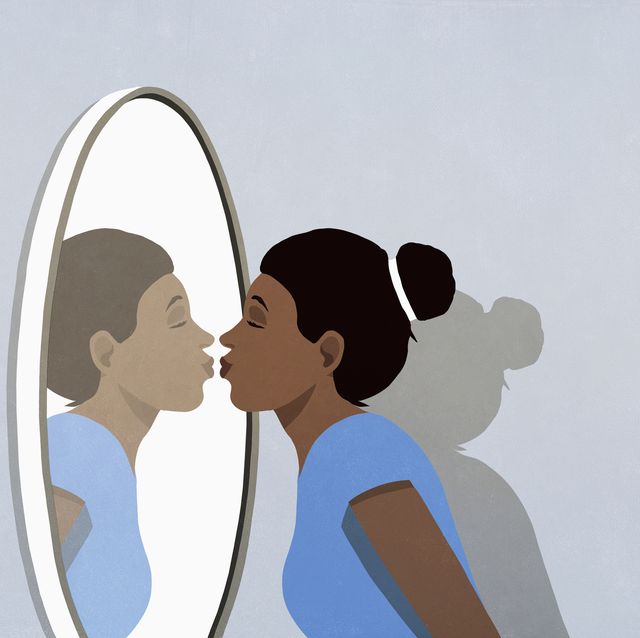woman kissing reflection in mirror