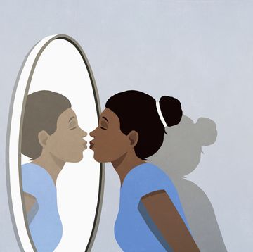 woman kissing reflection in mirror
