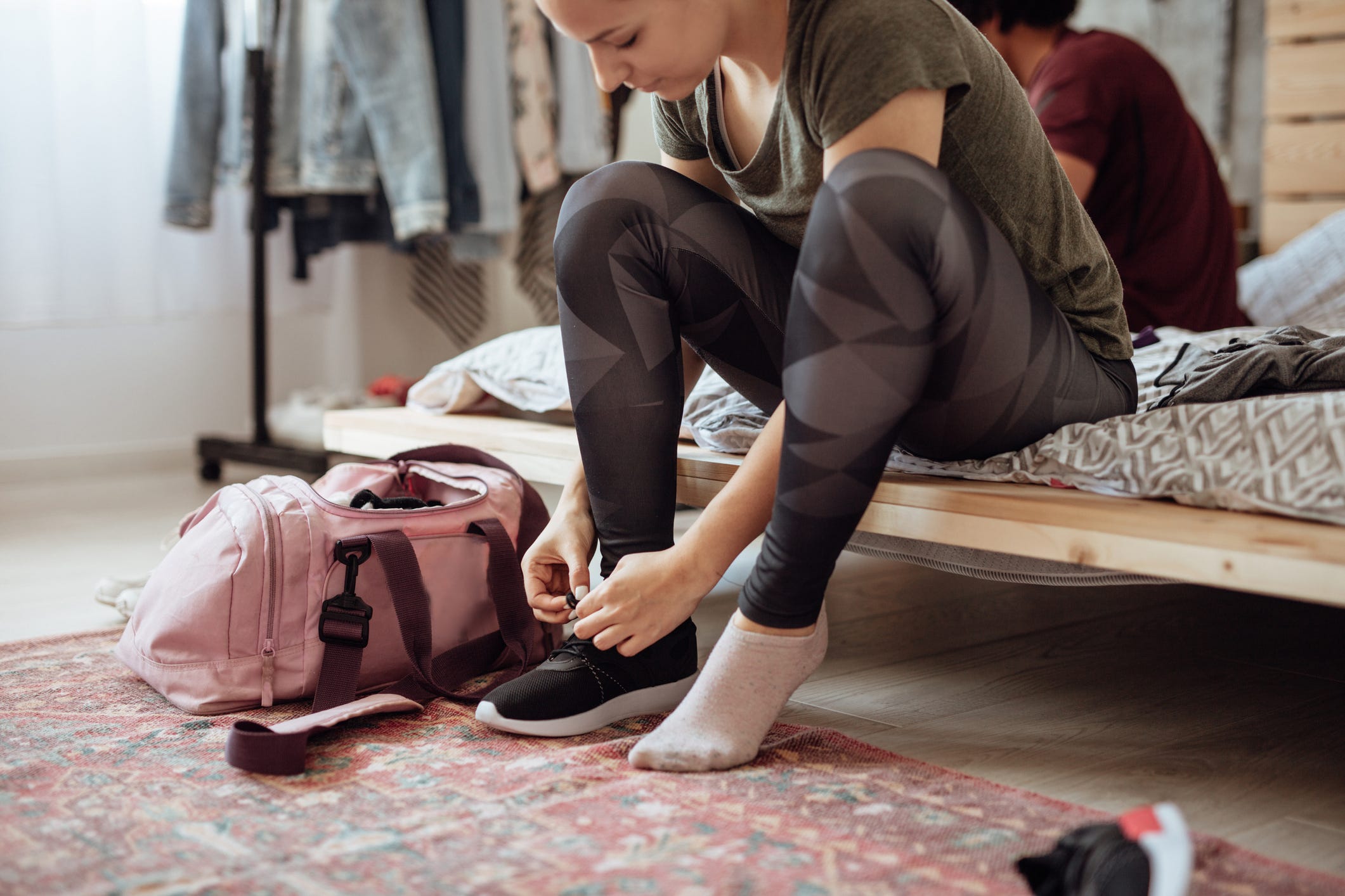 woman lacing up sports shoe