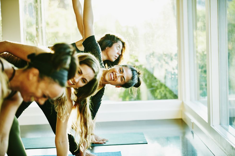woman laughing with friends during yoga class