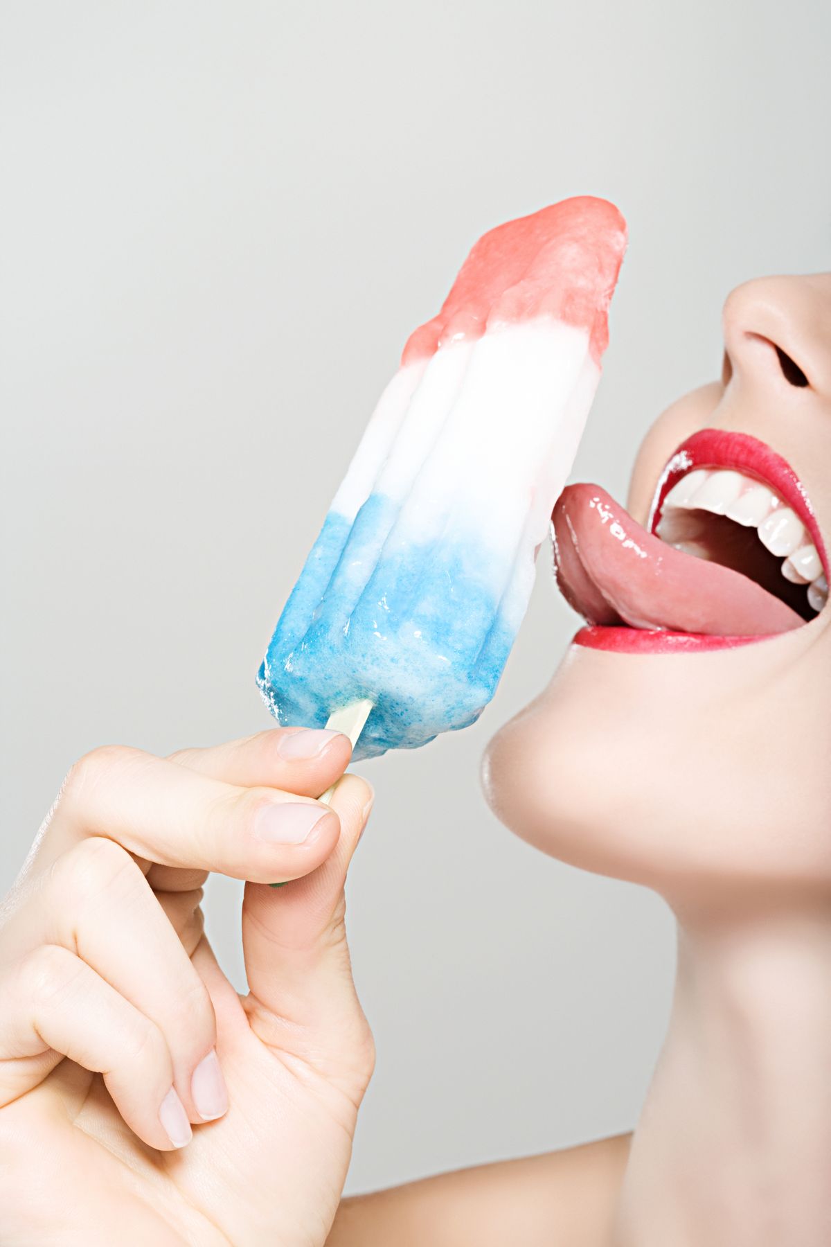 woman licking ice lolly