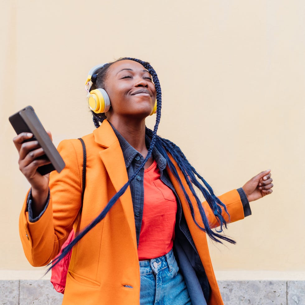 Self-care ideas woman listening to music on smart phone headphones