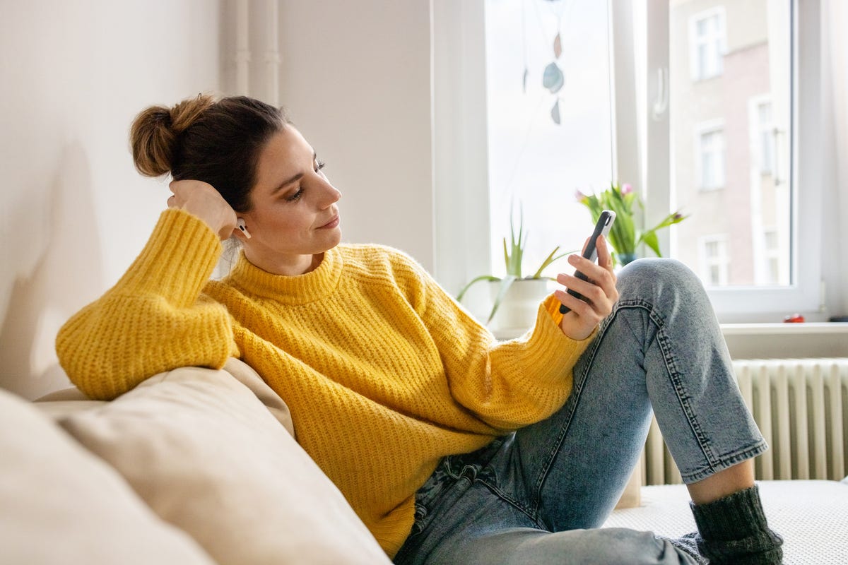 woman listening to relaxation audio from mobile app