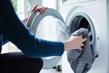 woman loading washing machine