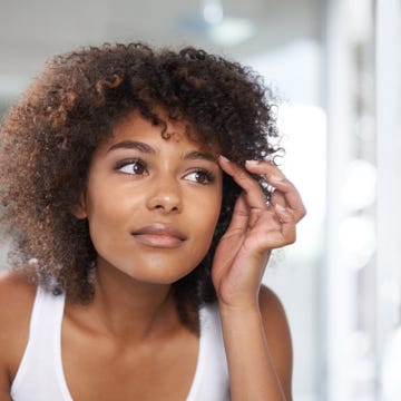 woman looking at mirror