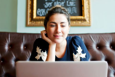 woman looking at screen in cafe