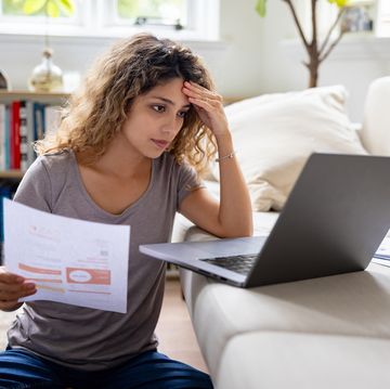 woman looking very concerned about her home finances