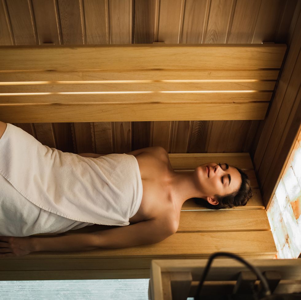 woman lying and relaxing in sauna wellbeing and mental health