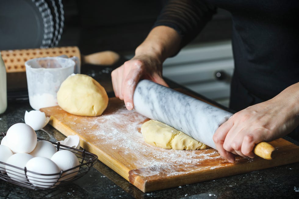Woman making a pie from flaky pastry dough