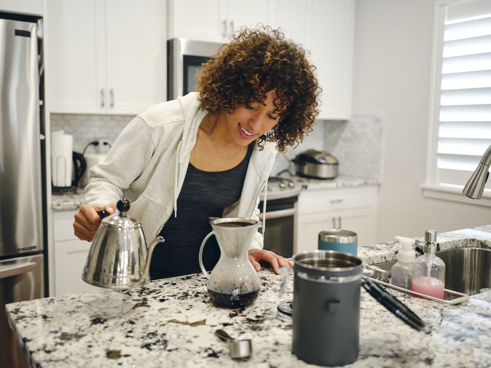 woman making coffee in a home kitchen