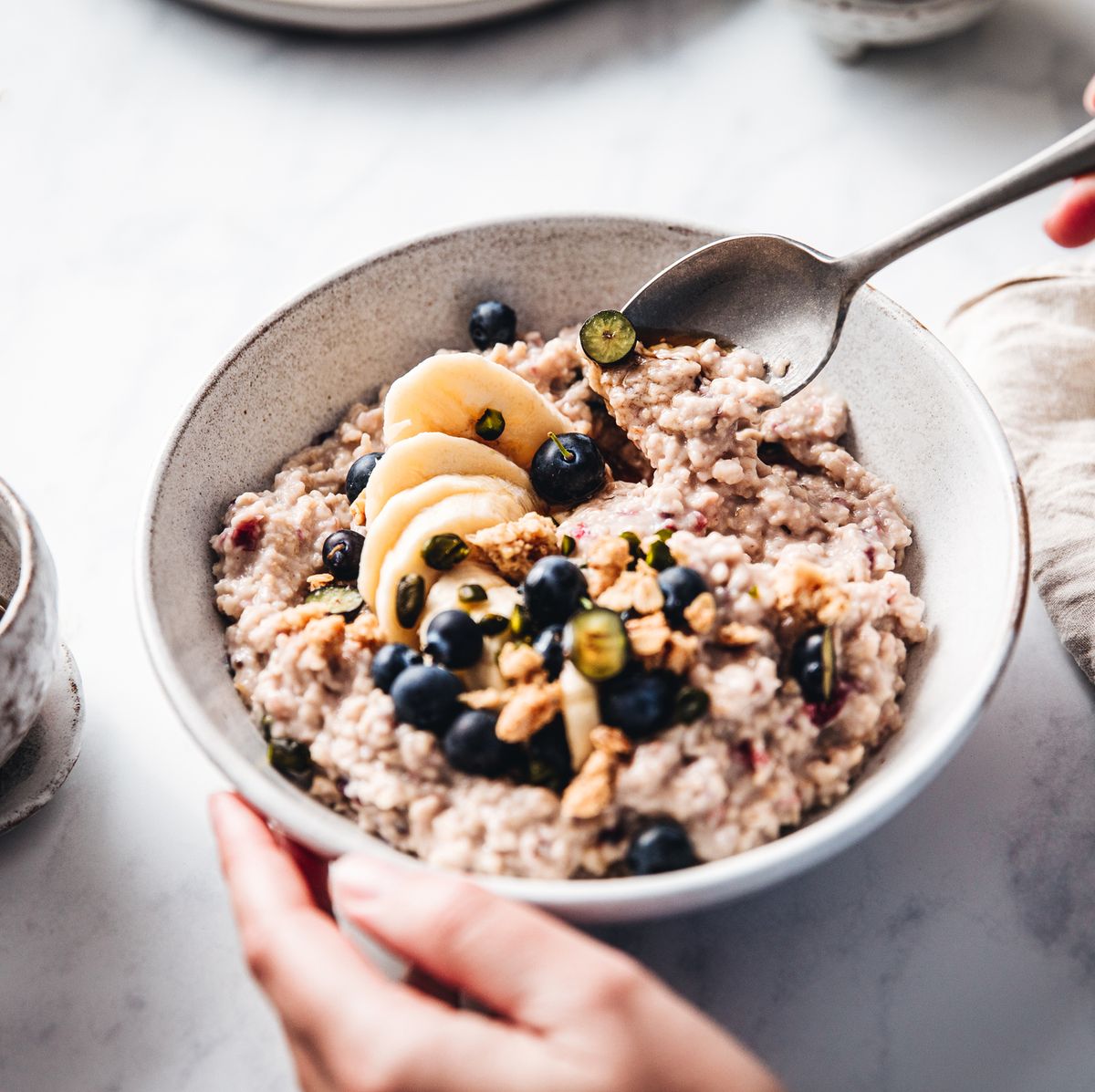 https://hips.hearstapps.com/hmg-prod/images/woman-making-healthy-breakfast-in-kitchen-royalty-free-image-1641491964.jpg?crop=0.668xw:1.00xh;0.213xw,0&resize=1200:*