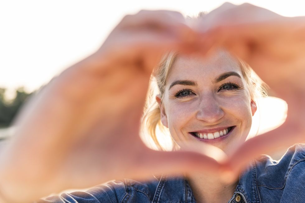 woman making heart shape with hands and fingers