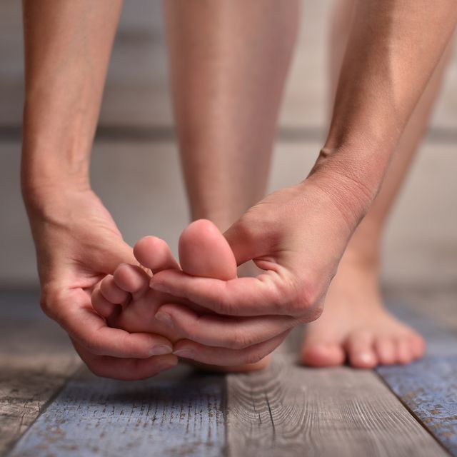 woman massaging her feet