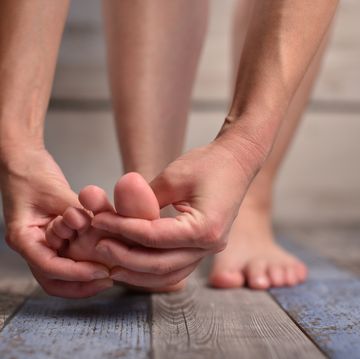 woman massaging her feet
