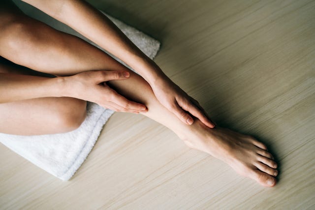 woman massaging her legs