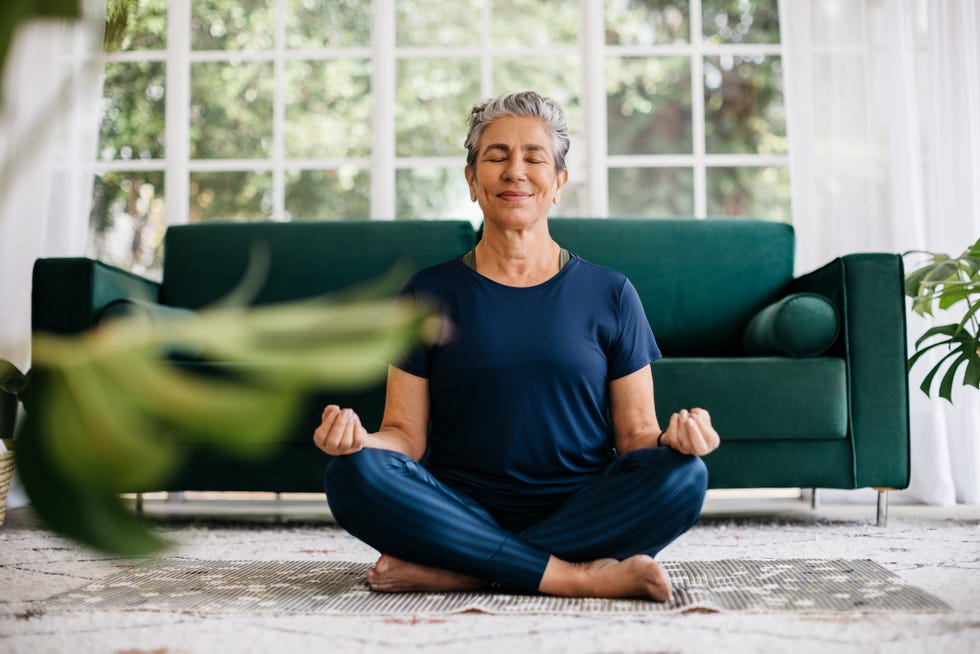 senior woman meditating in lotus position