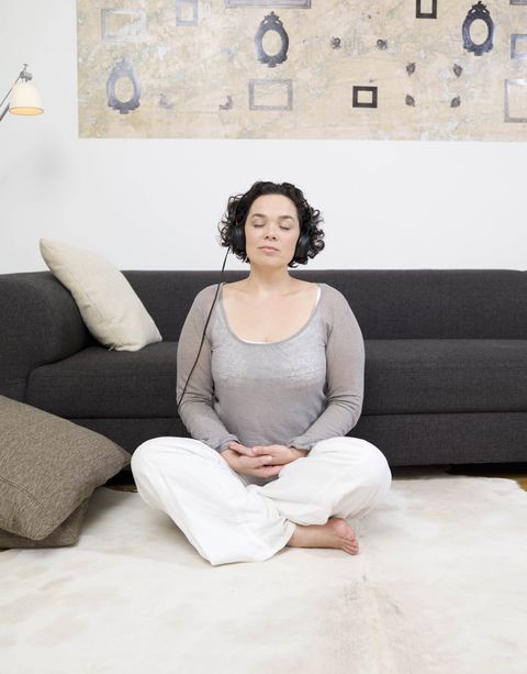 woman meditating, headphones on