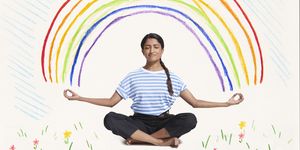 woman meditating with rainbow