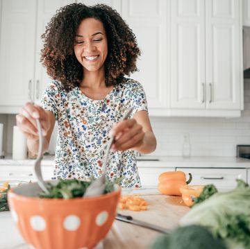 woman mixing a salad in the kitchen