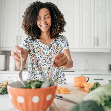 woman mixing a salad in the kitchen