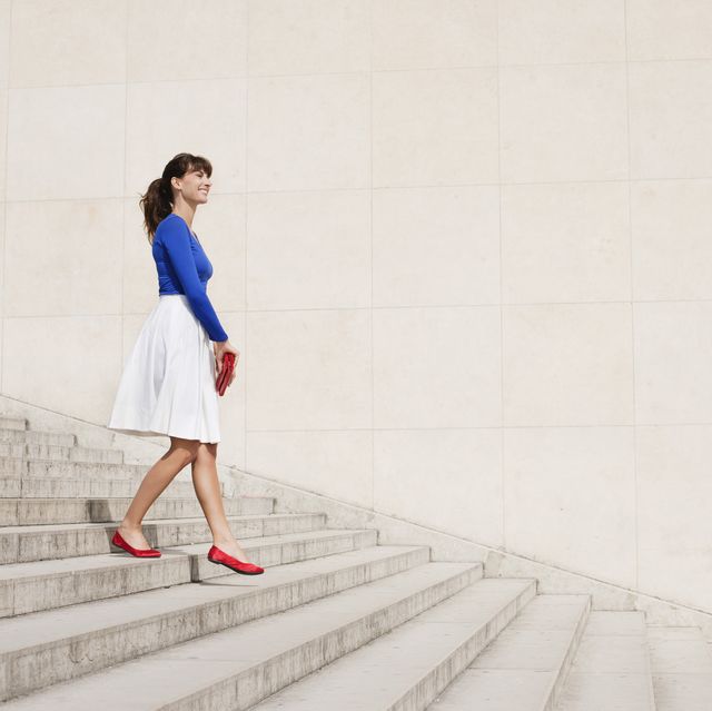 woman moving down steps