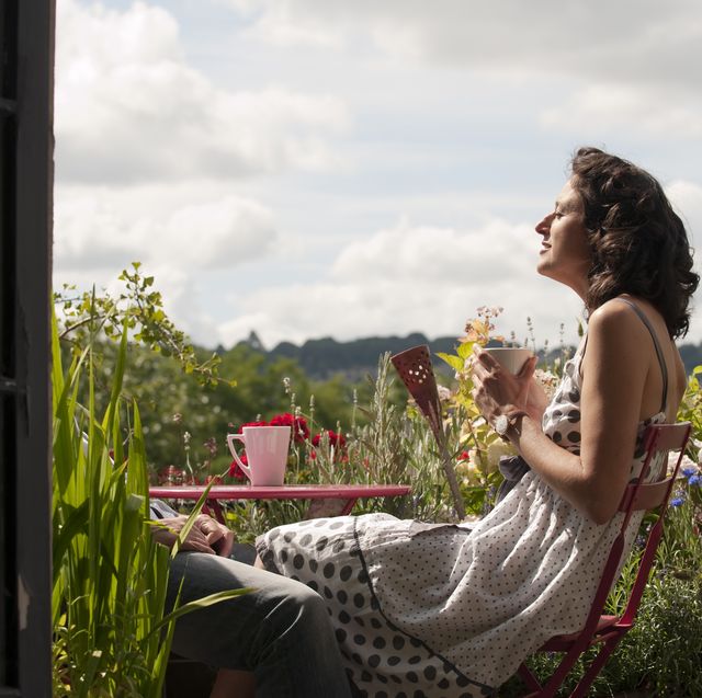 woman on balcony drinking tea