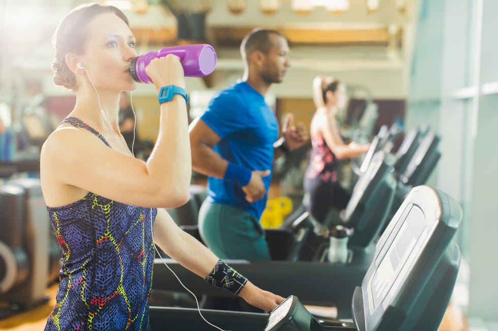 Woman on treadmill drinking water