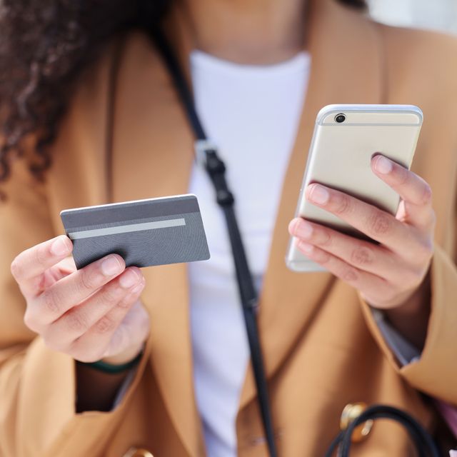 woman holding smartphone and gift card