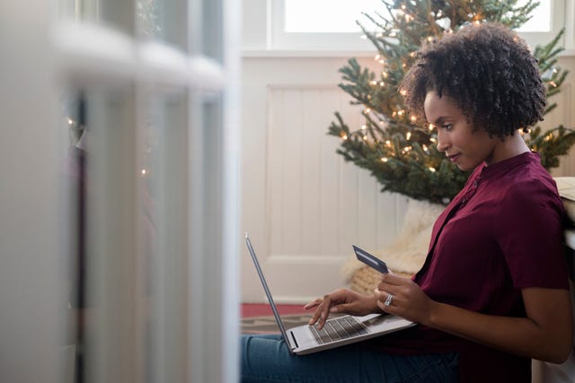 Woman online shopping on laptop at Christmas