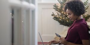 Woman online shopping on laptop at Christmas