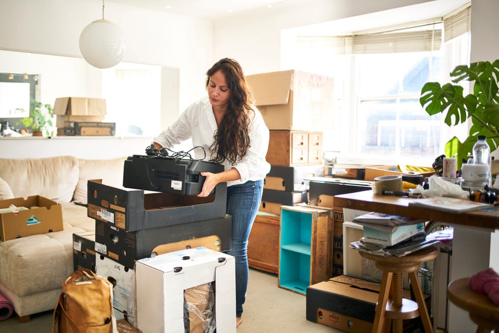 Woman packing a printer into a box