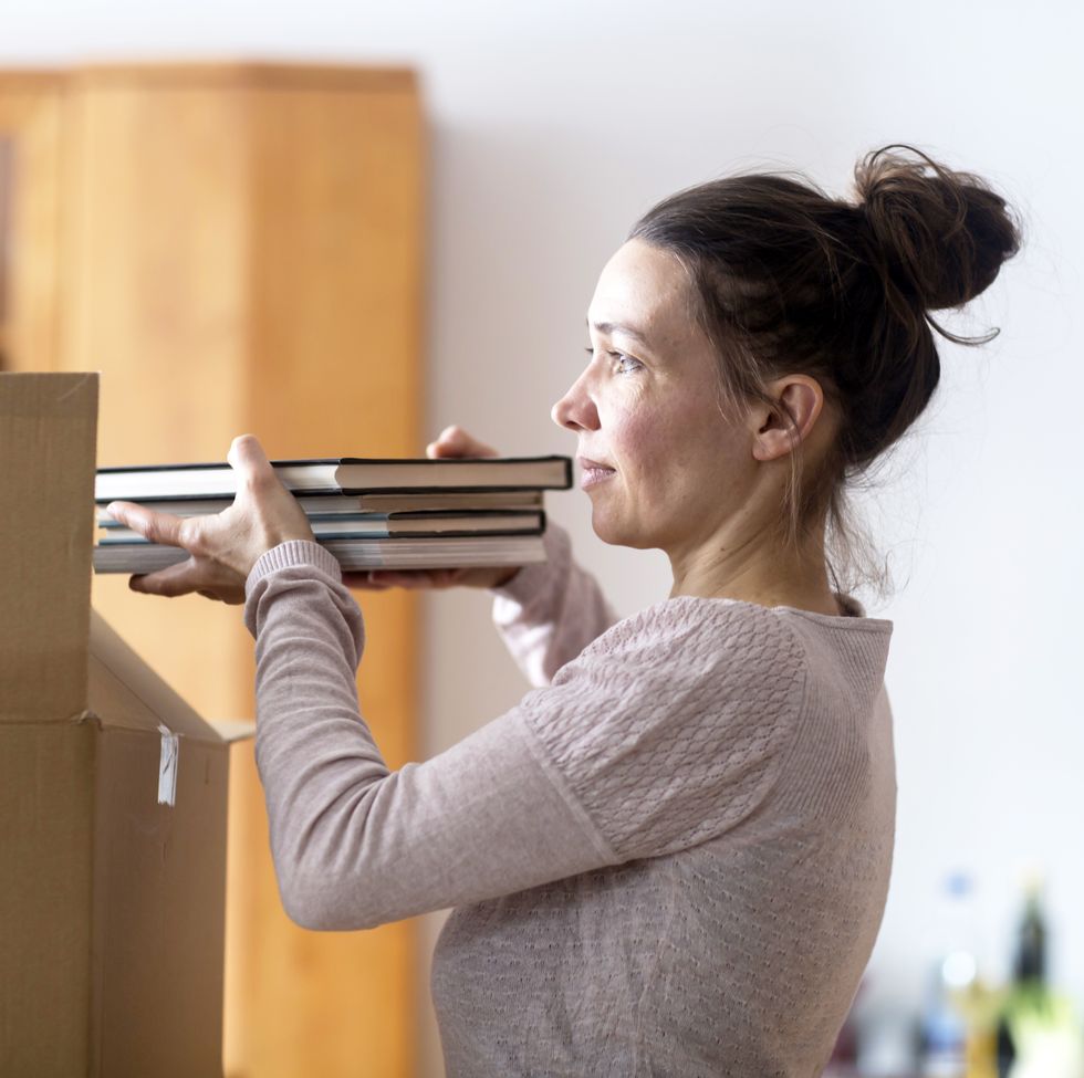 jobs for stay at home moms  - Woman packing books into cardboard box