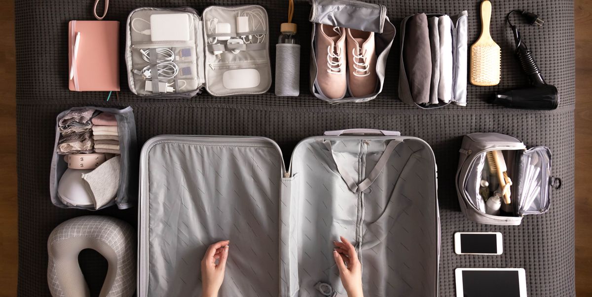 woman packing suitcase for travelling