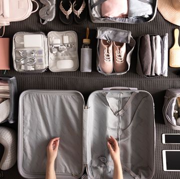 woman packing suitcase for travelling