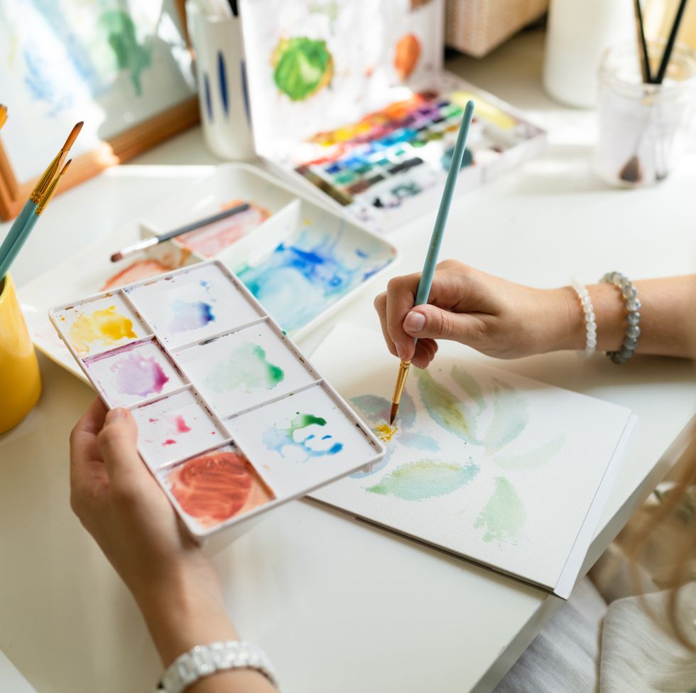 woman painting watercolor flower