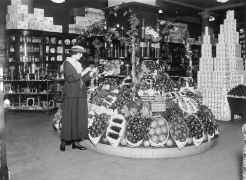 vintage photo of grocery store   woman shopping for fruit