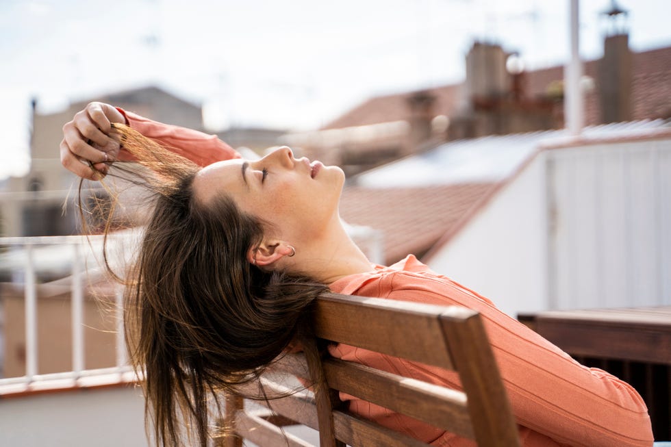 una mujer con la melena al viento en una terraza