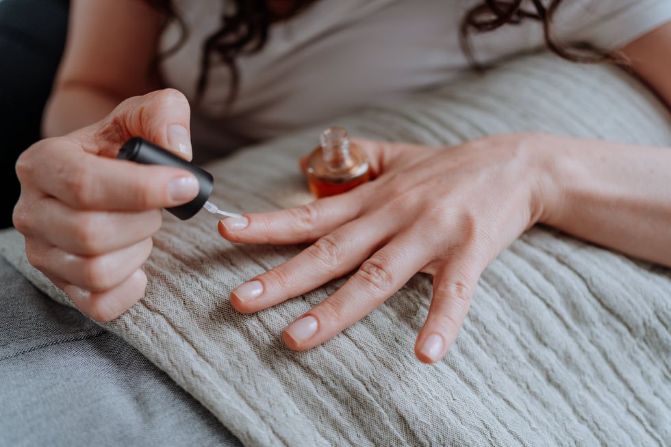 woman polishing her nails at home
